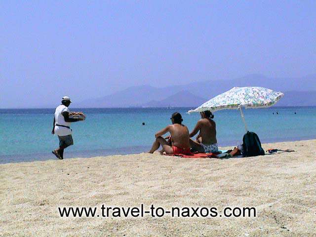 AGIOS PROKOPIOS - Man selling fruits on Agios Prokopios Beach.