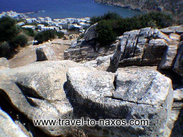 APOLLONAS KOUROS - The Kouros at Apollonas with the village in the background.